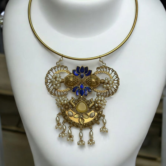 Amrapali Fusion Hasli Necklace – gold-tone necklace with intricate detailing, pearl accents, and vibrant blue enamel work. A statement fusion piece ideal for festive and contemporary outfits.