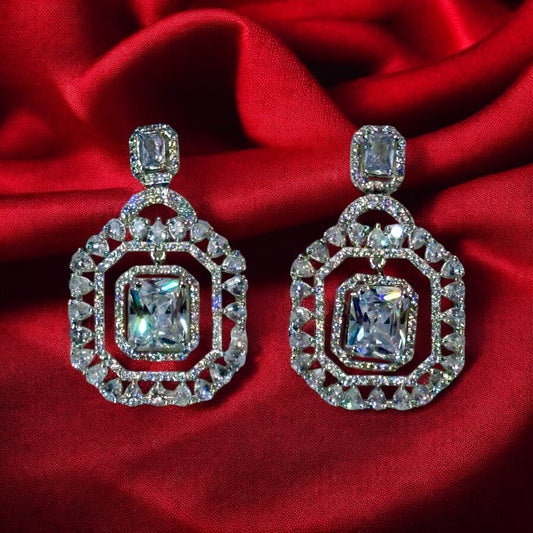 A pair of an American Diamonds Statement Earring on a royal red coloured fabric background