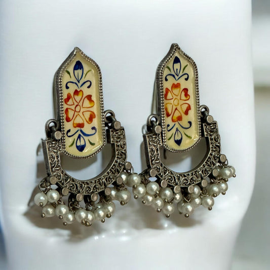 Fusion Hand Painted Statement Earrings with intricate floral motifs, vintage silver detailing, and pearl embellishments, displayed on a white stand.