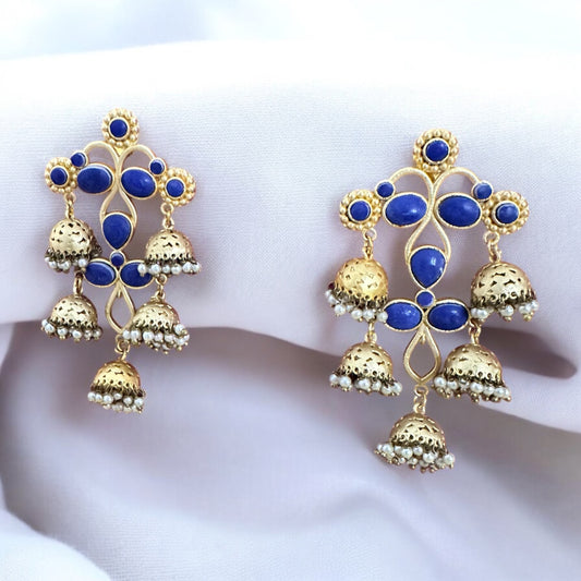 Gold Plated Statement Earring with dark blue stones on a white fabric background.