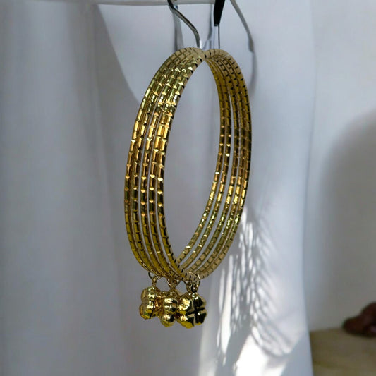 Golden bangle set featuring delicate ghungroo charms, ideal for traditional and festive occasions.