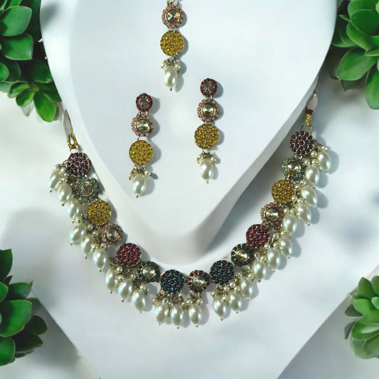 Pakistani Kundan Choker Necklace & Earrings With Tika decorated on a white colored jewellery display stand with a few plant leaves on corners.