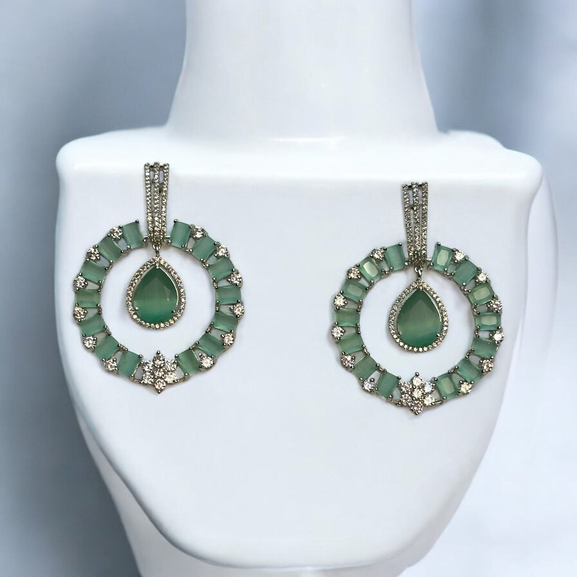 Premium American Diamond Light Green Earrings – circular earrings featuring light green stones, teardrop centerpieces, and sparkling American diamonds. Perfect for weddings and festive occasions.