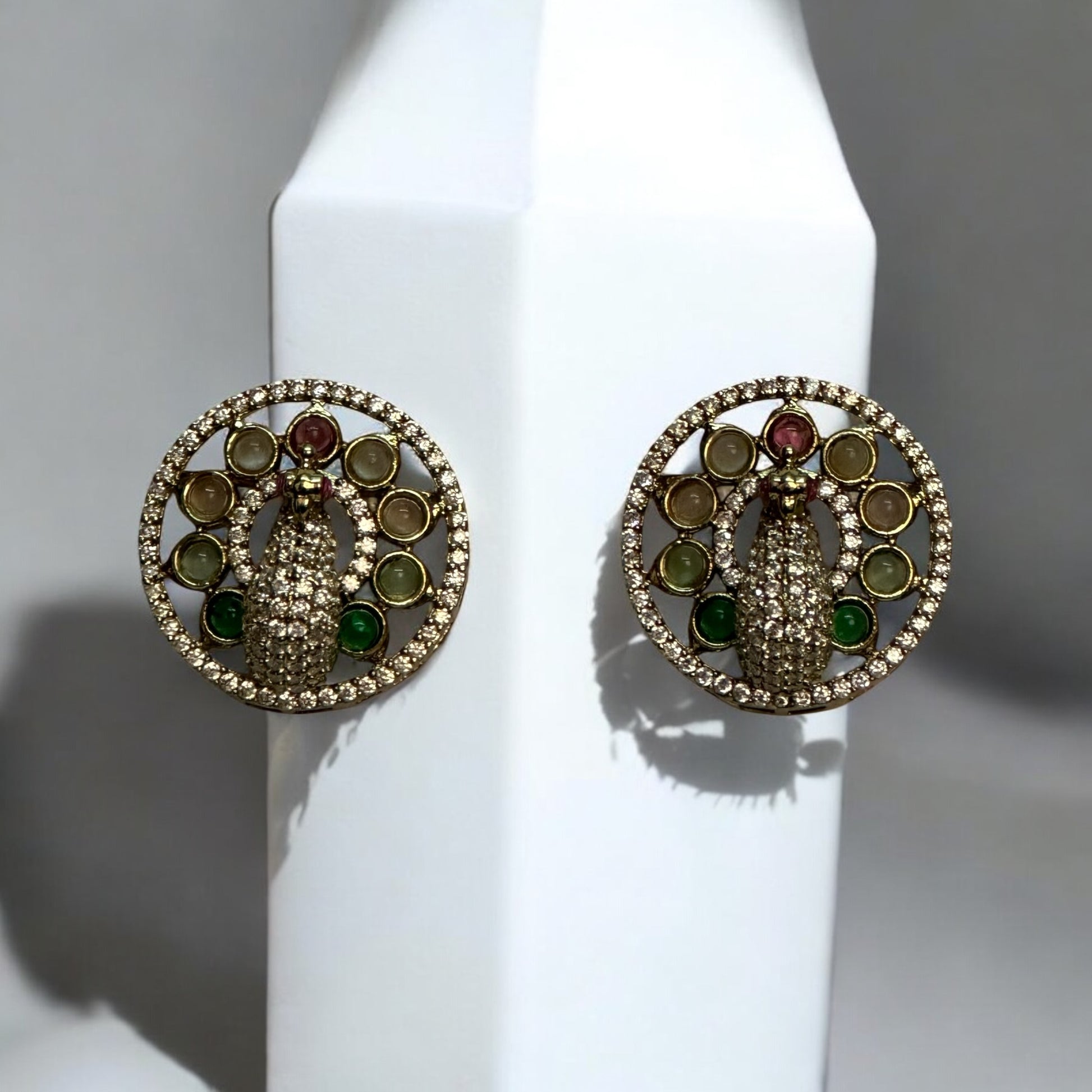 Premium Hasli Kundan Earrings with a peacock design, Placed on a white coloured jewellery display stand.