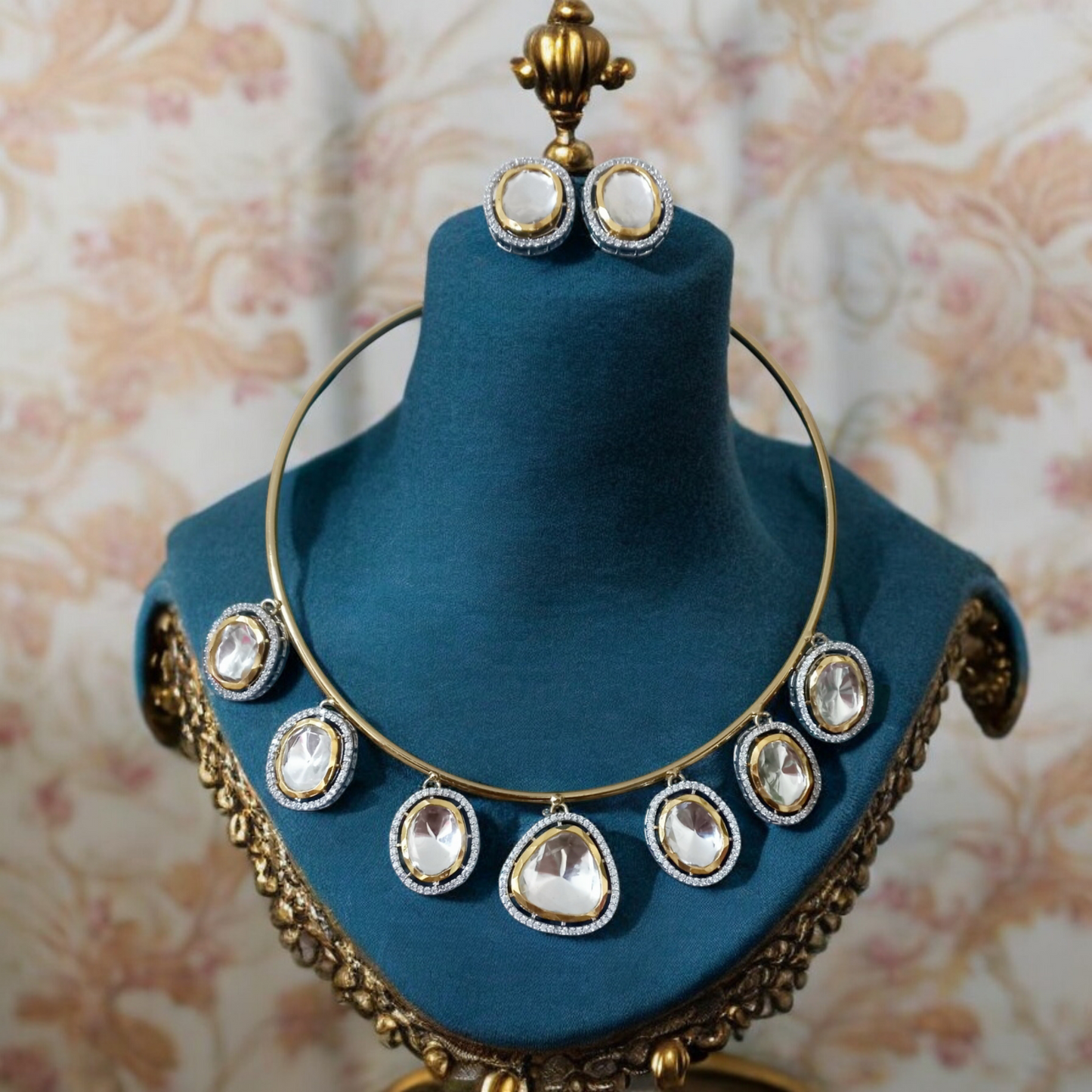 Premium Polki Kundan hasli-style necklace with radiant stones and matching earrings, displayed elegantly on a blue velvet bust.