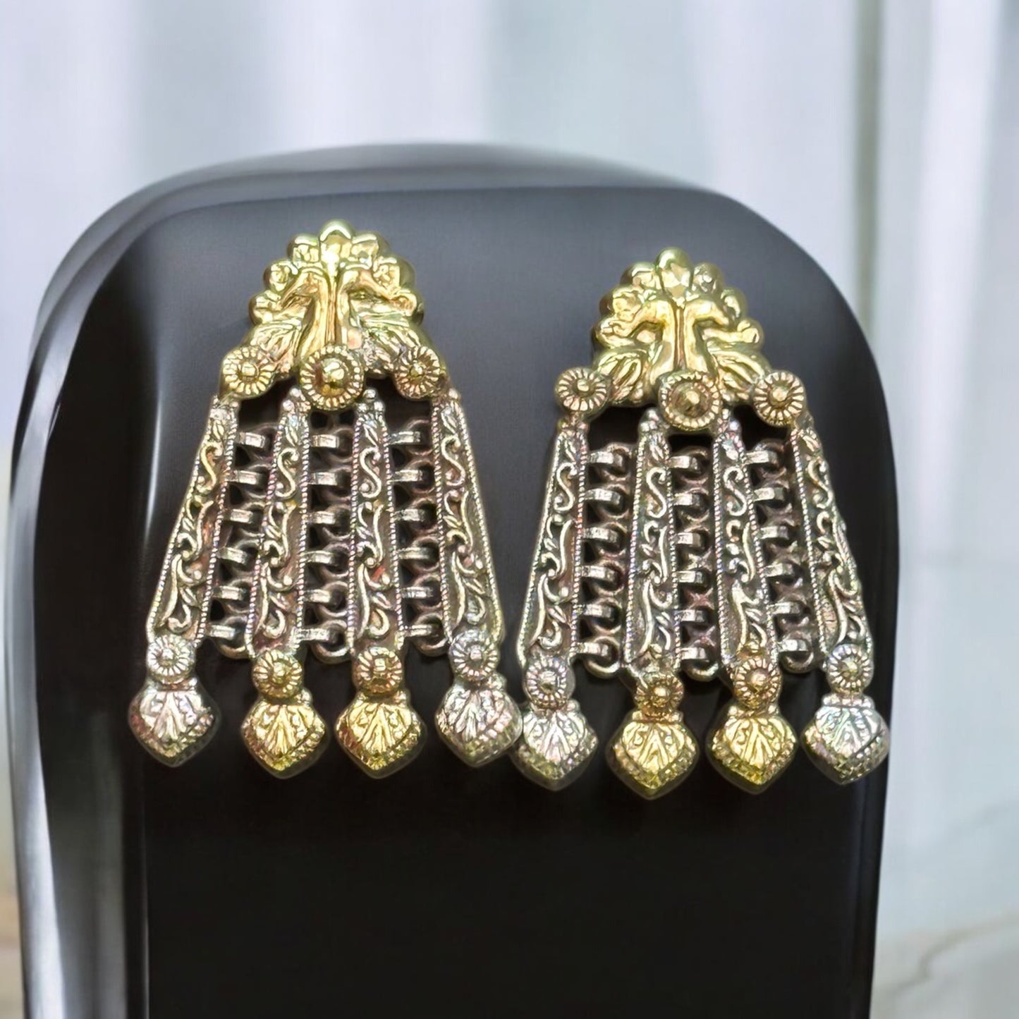 Premium silver replica kundan earrings featuring detailing and traditional design chandelier earrings, displayed on a black bust stand.