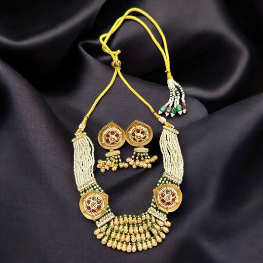 Rajwadi Kundan Necklace and Earrings lying on a black colored fabric.