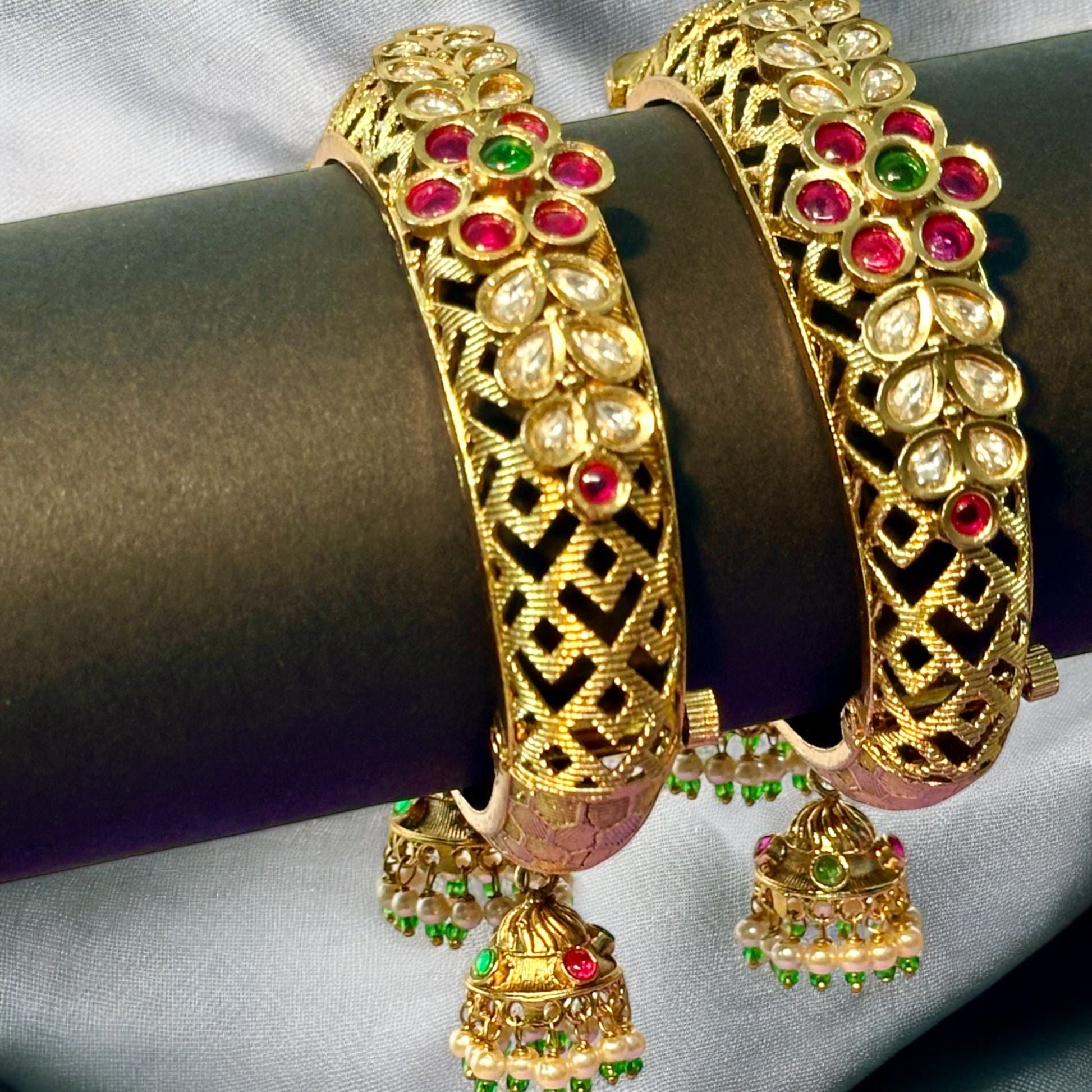 Rajwadi Premium Kundan Adjustable Bangles placed on a black roll with a white fabric background.