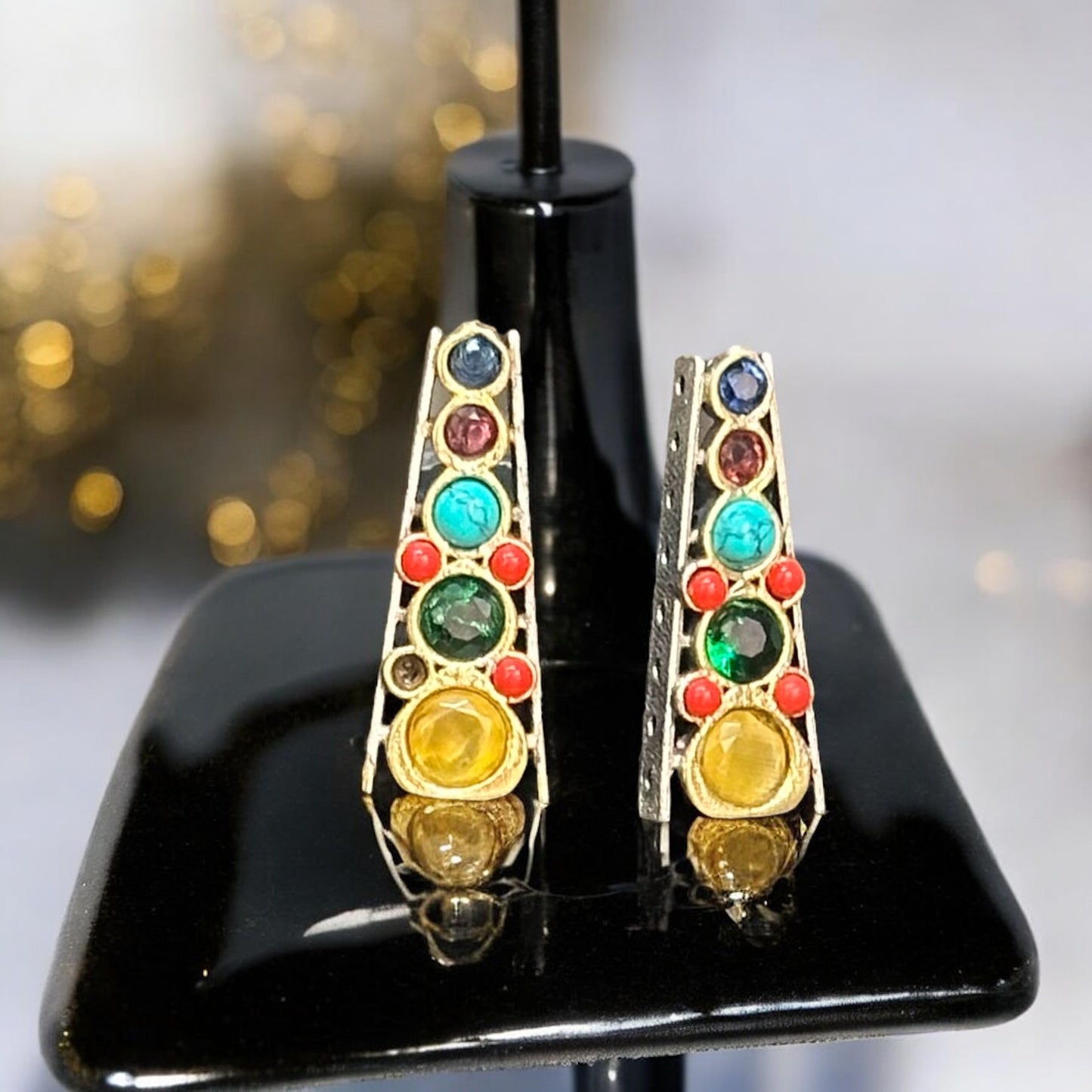 Matching Studs of a Royal Pearl Necklace Set, featuring colorful gemstones in red, green, and yellow,  displayed on a black jewellery display stand with a neutral background.